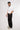 man wearing journey of curves unisex black trousers left view design