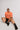 girl sitting at floor wearing brain size of a peanut unisex t-shirt front view