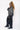 girl wearing charcoal strip unisex hoodie side view