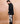 man wearing talk to me unisex trousers with black jacket side view design